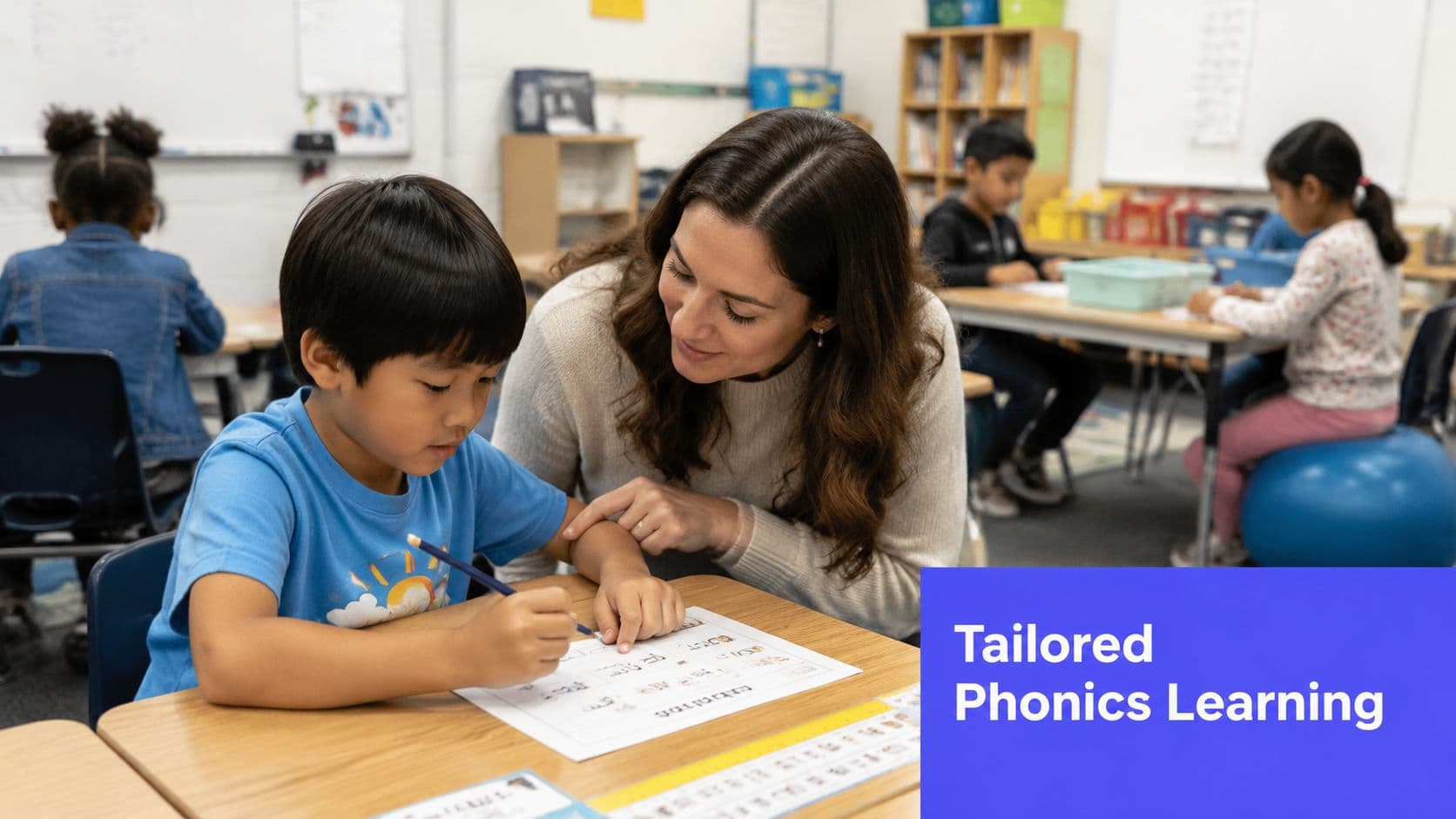 A teacher provides personalized phonics instruction to a young student in a supportive classroom environment.