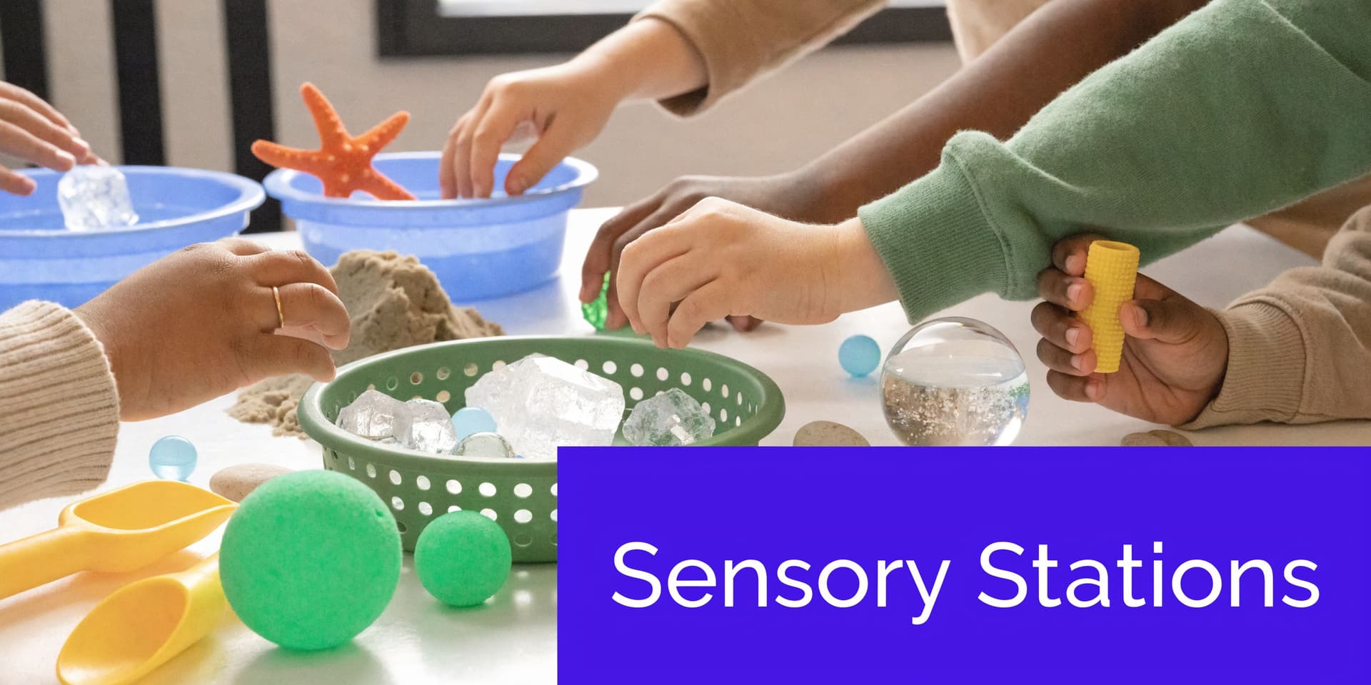 A group of children engaging with various sensory station toys and materials on a white table surface.