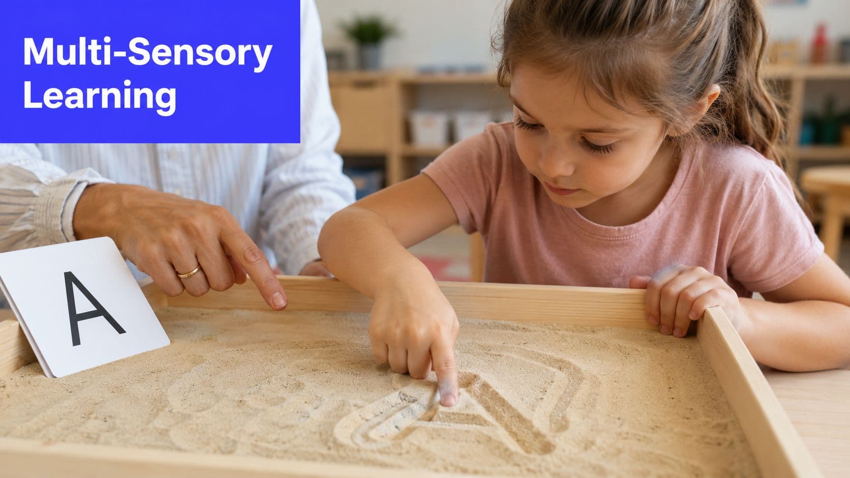 A young girl traces the letter A in a sandbox with an adult teaching her phonics.