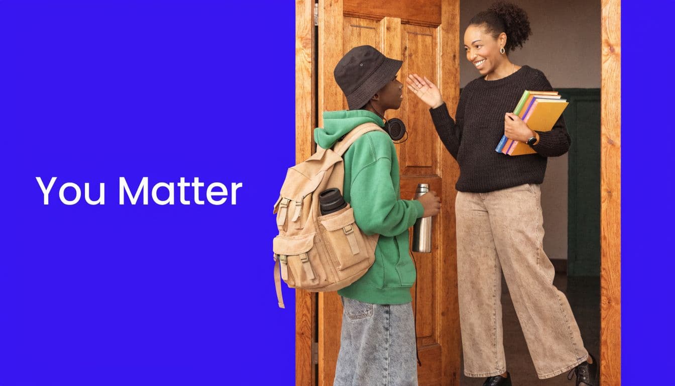 A teacher smiling while interacting with a high school student in a green hoodie holding a backpack.