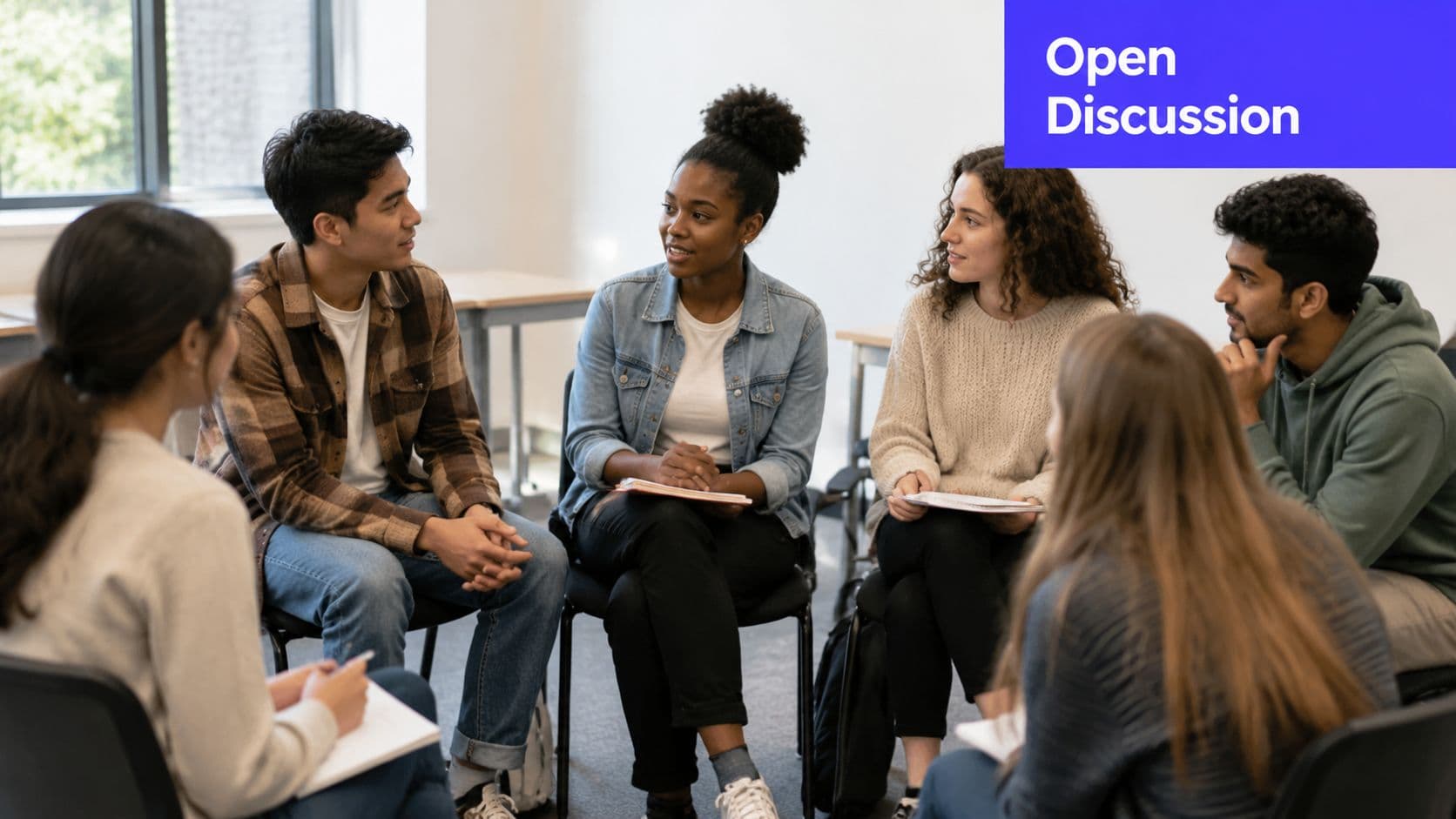 A diverse group of university students sitting in a circle for an open discussion in class.