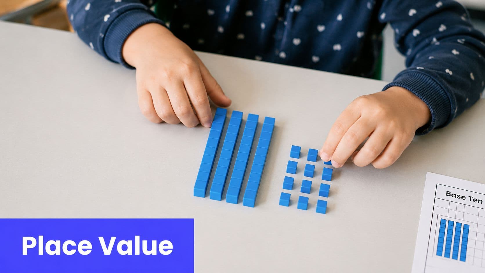 A child uses blue base ten blocks on a white table to practice place value math lessons.