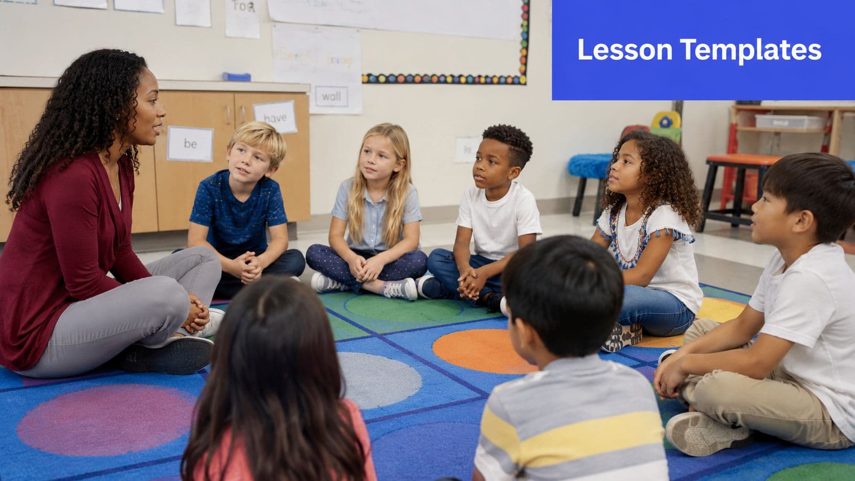 A teacher sits on a colorful rug leading a small group of elementary students in a lesson.